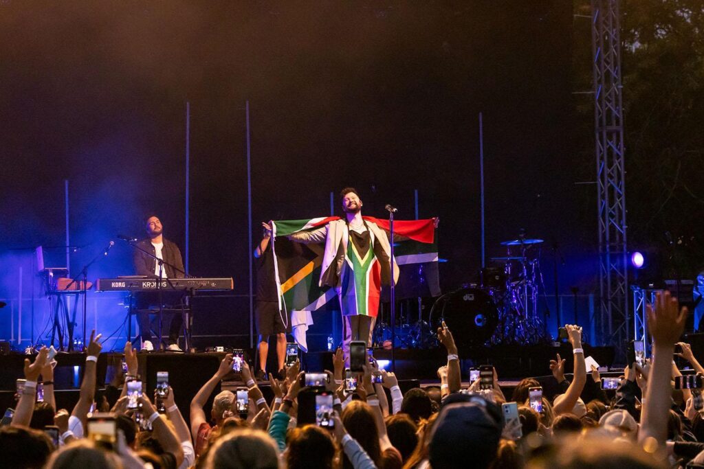 Calum Scott performs with South African flags at Zevenwacht Wine Estate for a sold out Cape Town show in 2023